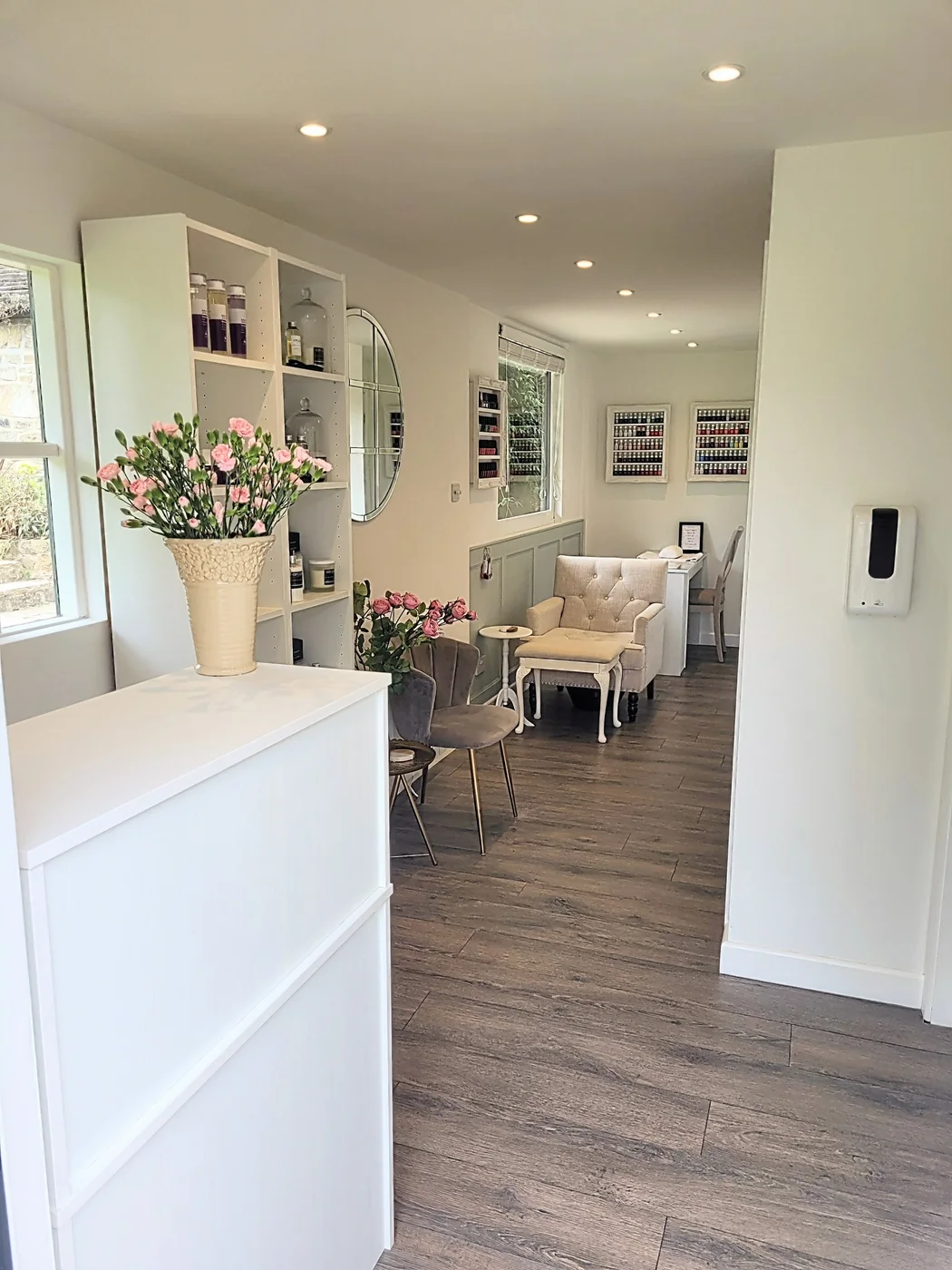 Inside VGBeauty's garden salon, with fresh flowers, soft seating and a manicure table